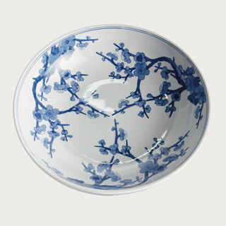 Blue and white Chinoiserie footed ceramic bowl featuring a classic botanical pattern on a crisp white base. A timeless spring decor accent ideal for dining tables, kitchen islands, consoles, shelves, and thoughtfully styled interiors.