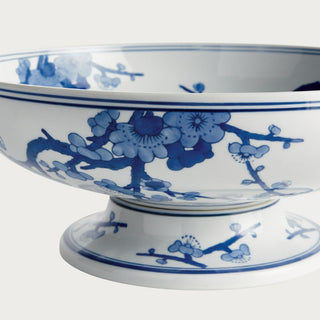 Blue and white Chinoiserie footed ceramic bowl featuring a classic botanical pattern on a crisp white base. A timeless spring decor accent ideal for dining tables, kitchen islands, consoles, shelves, and thoughtfully styled interiors.