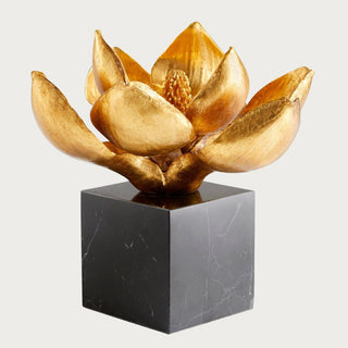 Edelweiss decorative sculpture with a dimensional gold flower on a square black marble base with natural white veining.