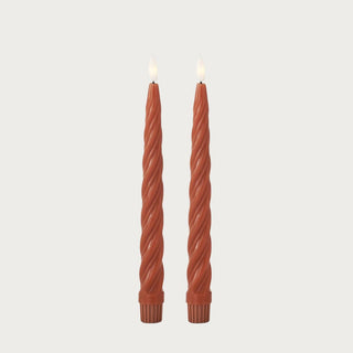 Set of two Ember Spiral LED Taper Candles with warm rust-orange wax finish, spiral texture, and glowing flameless candle tips for fall decor.