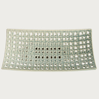 Rectangular woven ceramic tray with open lattice design and soft neutral glaze, styled as an elegant decorative accent