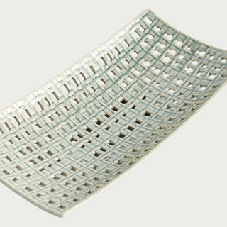 Rectangular woven ceramic tray with open lattice design and soft neutral glaze, styled as an elegant decorative accent