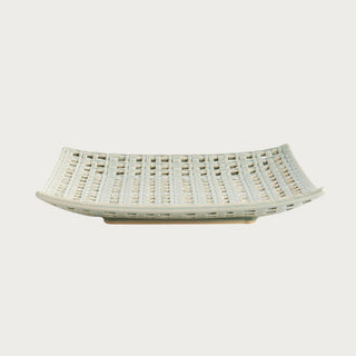 Woven square clay tray with open lattice design and soft neutral glaze, styled as a sculptural decorative accent