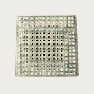 Woven square clay tray with open lattice design and soft neutral glaze, styled as a sculptural decorative accent