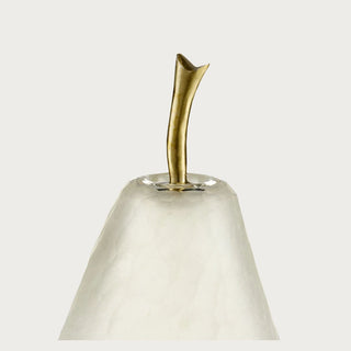 Close-up of a frosted white glass decorative pear showing its translucent textured glass surface and curved gold metal stem.