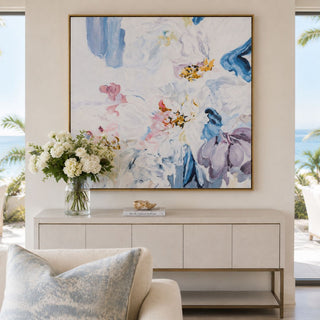 ethereal abstract floral wall art in brushed silver frame styled above modern coastal console table with ocean view and soft neutral decor