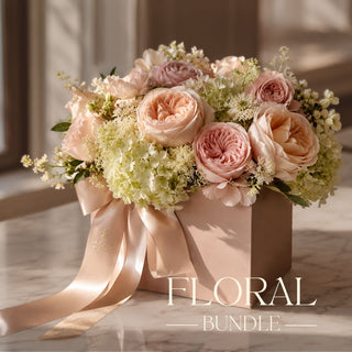A gift box in a luxury home, sitting on a marble table top. Gift box contains various faux florals