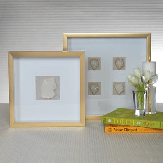 An antiqued gold box frame with four clear crystals with a gold rim set on a soft gray linen fabric backing. The remainder of the inner frame is set on a matte white/cream background. Third & Main, Home Decor, Everyday Decor, Summer Decor, Spring Decor, Seasonal Decor, Luxury Decor, Luxury Living, Contemporary Decor