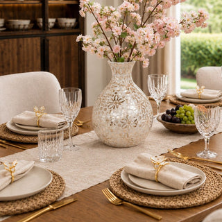 glass floral napkin rings styled on neutral linen napkins with mother of pearl vase pink florals and elegant dining table setting
