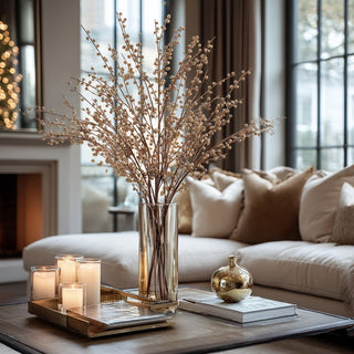 Gold beaded berry stems displayed in tall glass vase on coffee table with candles and neutral décor – sophisticated 47-inch faux stems for modern living room styling.