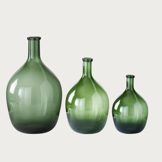 Three translucent green glass bottle vases shown together in Small 11-inch, Medium 15.5-inch, and Large 19.75-inch sizes with rounded bodies and narrow necks.