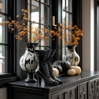 Halloween resin witch boots styled on entryway console