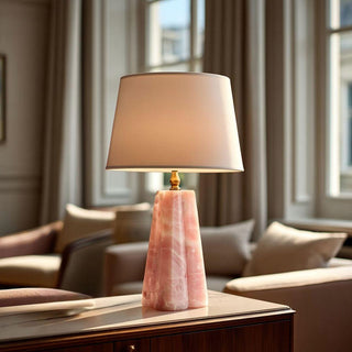 Pink quartz–style mini table lamp with a faceted resin base and linen shade, styled on a warm wood console table with soft morning light in an elevated quiet luxury living space, perfect for refined spring home décor.