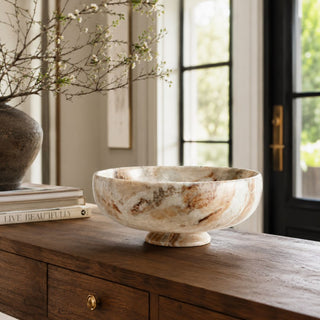 A warm, layered entryway moment where natural marble, rich wood tones, and soft daylight come together to create a space that feels quietly luxurious and beautifully lived in.