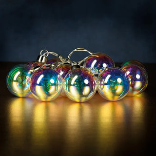 String of colorful glass ball lights that would look beautiful styled on a tree, on a dining room table, in a large hurricane or on a fireplace holiday decorated mantel with Christmas trees and deer. Third & Main home decor.