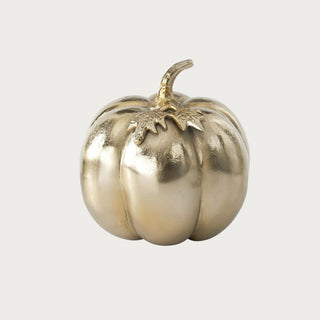 Large soft matte gold aluminum pumpkin measuring 8.5 inches high by 8 inches wide with rounded ribs, sculpted leaves, and curved stem.
