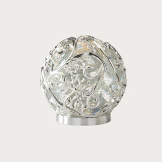 Large silver scrolled snowflake LED globe with intricate scroll pattern and glittering illumination – refined decorative holiday accent with built-in timer for modern home décor.