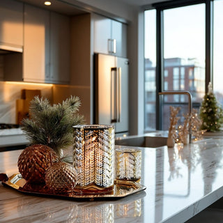 Add warmth and elegance with this metallic gold laser-etched hurricane candle holder. A modern, luxe accent perfect for winter or year-round décor. Third and Main, Home Decor
