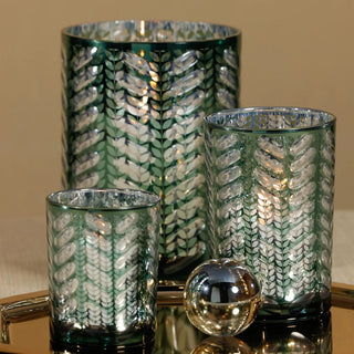 Bring organic sophistication to your space with this metallic green laser-etched hurricane candle holder—where nature meets modern elegance. Third & Main, Home Decor, Holiday Decor, Winter Decor