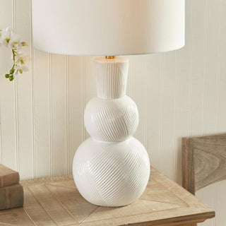 In a classic clean white ceramic with hand carved markings along the body, this lamp is made for the traditional setting. A generally scaled white linen shade &amp; simple brass finial finish off the look.Max wattage: 100W;-Socket: E26
Third & Main, Home Decor, Lighting, Table Lamp, Side Table Lamp, Contemporary Lighting, Luxury Home, Luxury Lighting, Hand Carved Detail