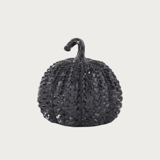 Low rounded glossy black resin pumpkin with raised embossed texture, reflective black finish, and curved stem for contemporary fall and Halloween tabletop styling.