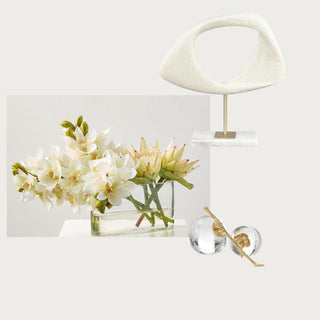Luxe Version 3  Curated Home Decor Box Third & Main, Includes a premade real touch floral arrangement with cymbidium orchids in creamy white and protea stems in a yellow green in an oblong glass vessel with white floral rock in the bottom, a white and marble sculpture object and a beautiful crystal glass and gold detail pomegranate sculpture. Home Decor Box, Luxury Home Decor, Luxury Decor, SpringHome Decor, Real Touch Floral Arrangement 