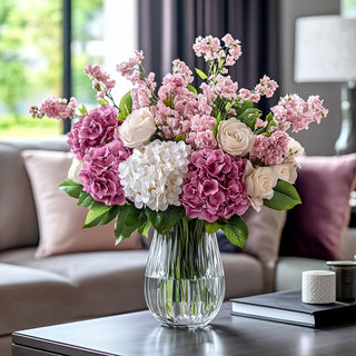 A pretty floral arrangement of mauve true bloom floral real touch hydrangeas and other complementary florals in a glass vase sitting on a coffee table in a contemporary decor style living room, Third & Main True Blooms Florals are real touch
