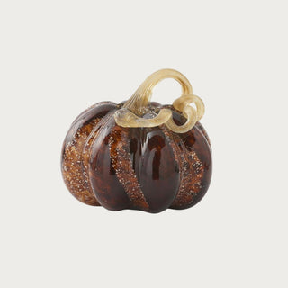 Medium brown speckled handblown glass pumpkin measuring 6 inches high by 7 inches wide with deep amber-brown glass and a sculptural looping stem.