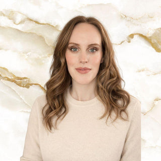 Meet Mylene our Graphic Designer for Third & Main Woman with long brown hair against a marble background