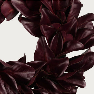 Close-up of the Merlot Magnolia Leaf Wreath showing layered Southern magnolia-inspired leaves with deep wine color, visible veining, curved edges, and subtle sheen.