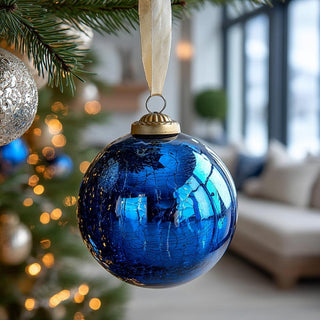 Mirrored blue crackled glass ball ornament reflecting holiday lights – sophisticated handcrafted glass ornament for timeless Christmas tree décor.