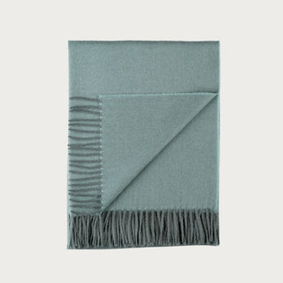 Misty Mountain Green baby alpaca throw blanket folded with fringe detail, sized 51x71 and made from 100% baby alpaca.