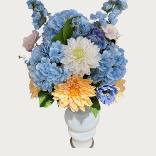 A premade summer floral arrangement for modern farmhouse decor lvoers- blue hydrangeas, blue delphinium, yellow dahlias, cream dahlias, anemone, and light pink buttercups 