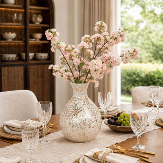 A softly layered dining moment featuring delicate cherry blossoms, luminous mother of pearl, warm wood tones, and effortless entertaining style inspired by elevated Southern living.
