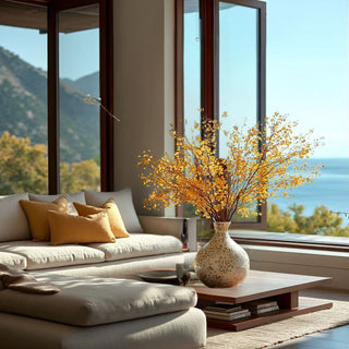 Modern living room with a sofa, coffee table, and mother of pearl decorative vase with yellow aspen branches.