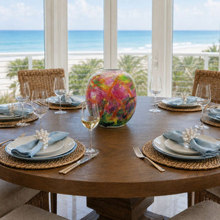 colorful artistic porcelain vase with vibrant fuchsia green yellow and blue painterly finish styled as dining table centerpiece in luxury coastal home