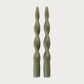 Set of two olive green twisted taper candles shown without candle holders, featuring a sculptural spiral silhouette for contemporary tabletop styling.