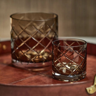 Pair of walnut-colored hand-cut glass vases displayed on leather tray – elegant diamond-cut glass hurricanes for modern tabletop or bar styling.