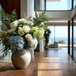 Real touch parsley fern greenery layered with hydrangea and ivory roses in modern coastal Santa Monica living room styled on wood console table
