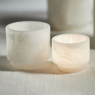 Polished natural alabaster multi-use vessel and 3.75-inch candle holder shown together, highlighting creamy white stone variation and soft translucency.