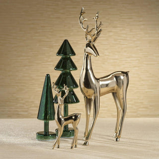 Polished metallic gold deer figurine in modern living room with greenery and glass trees – sophisticated Christmas décor accent for contemporary interiors.
