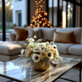 Premade Floral arrangement by Third & Main styled on a marble coffee table with a blurred background of a living room.
