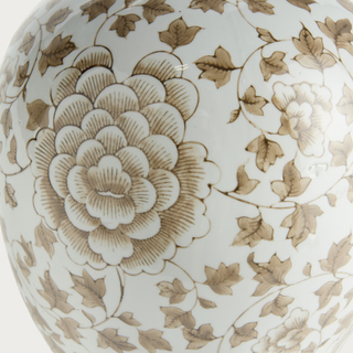 Close-up of the Province Bottle Vase showing a large taupe flower surrounded by trailing leaves and smaller blossoms across the ivory porcelain surface.