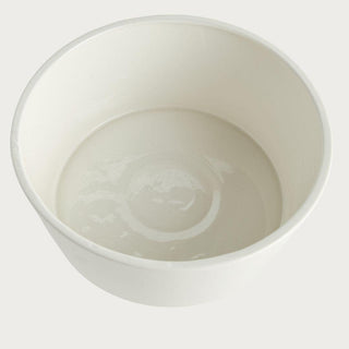 Creamy white ceramic decorative footed bowl with smooth finish and sculptural pedestal base