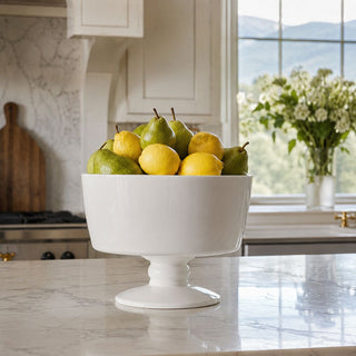 A bright, layered kitchen moment featuring fresh citrus, soft natural light, and the Señora Footed Bowl styled as an effortless everyday centerpiece