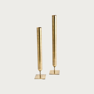 Set of two tall antiqued brass iron vases measuring 19.5 and 16.25 inches high with narrow cylindrical forms and square bases.
