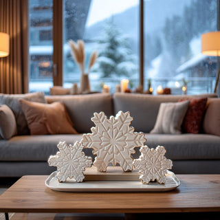 Set of 3 white dolomite tabletop snowflakes with embossed detailing and gold edges styled on black table — elegant winter and holiday home décor by Third & Main.”