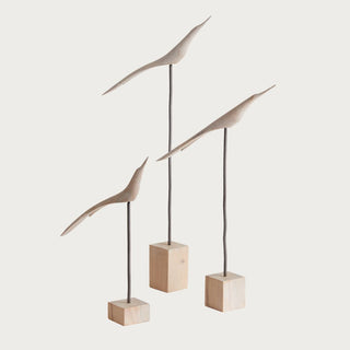 Set of three Palilo wood and iron bird sculptures on natural wood bases with slender vertical stands and elongated silhouettes