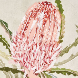 Close-up of a pink protea flower with green leaves on a beige background