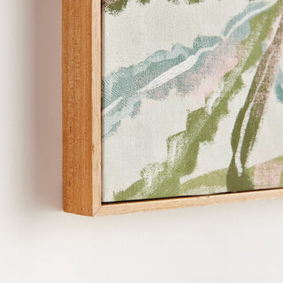 Framed artwork with a natural wood border on a white wall